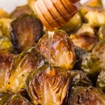 Drizzling honey over Honey Roasted Sweet Brussels Sprout.