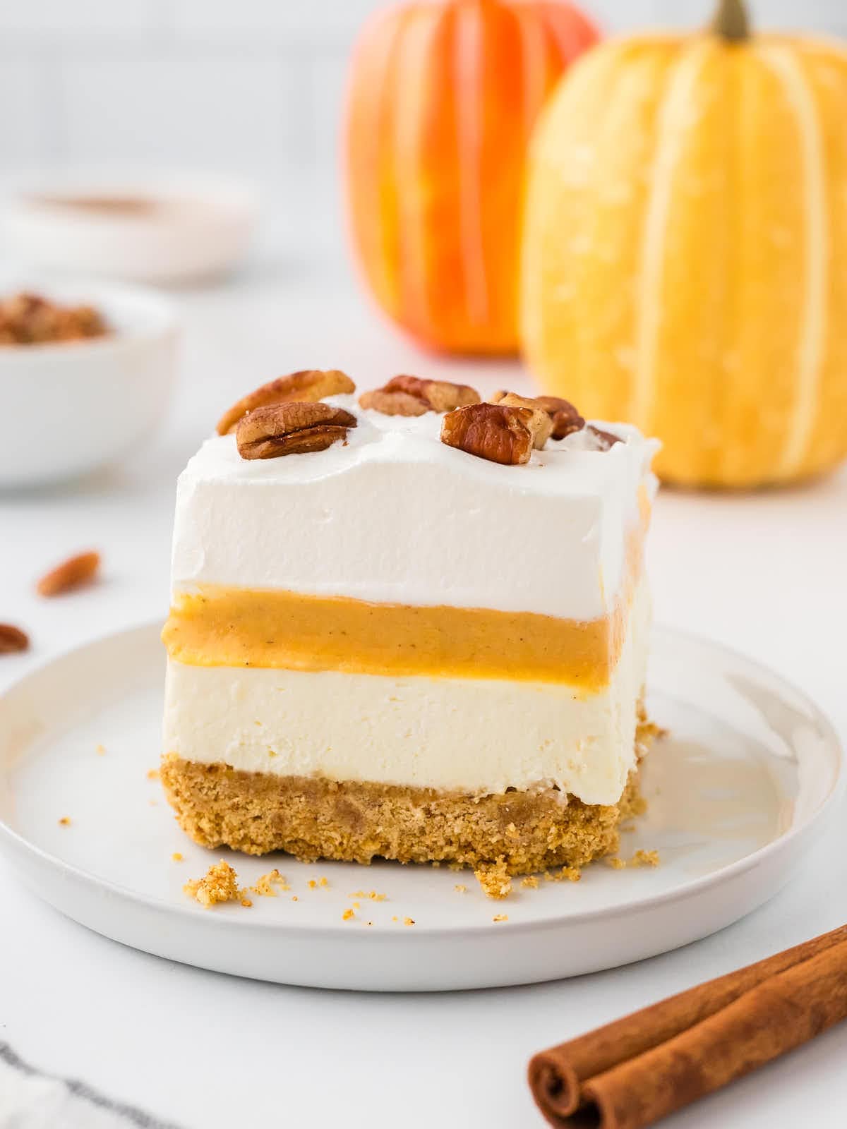 A slice of No-Bake Pumpkin Delight on a white plate.