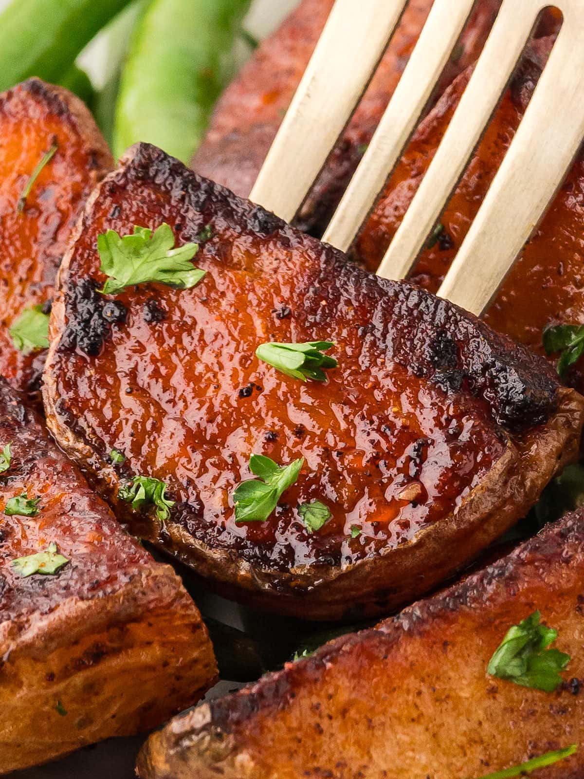 Closeup of a fork with a piece Roasted Potatoes.