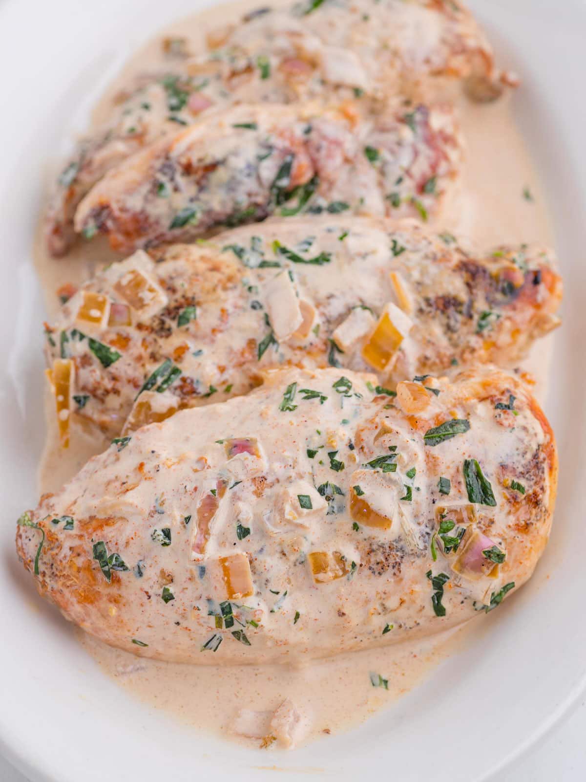 Closeup of Tarragon Chicken on a large white serving plate.