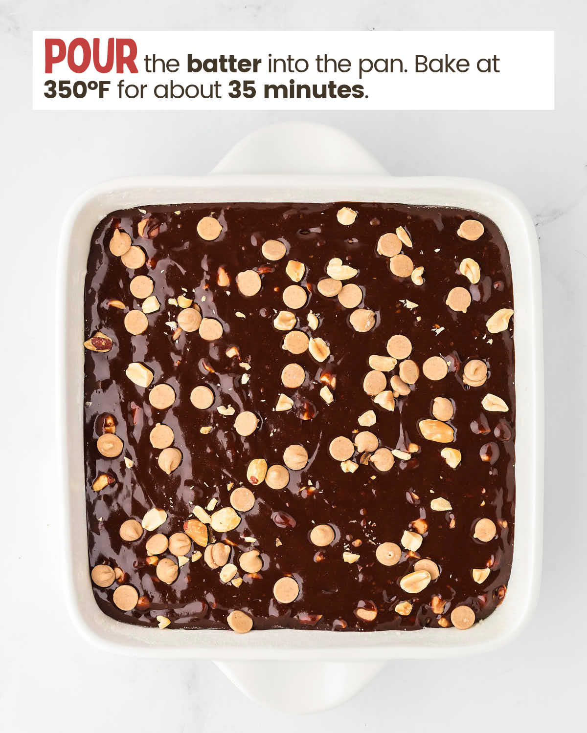 Brownie batter with peanuts and peanut butter chips in a baking dish.