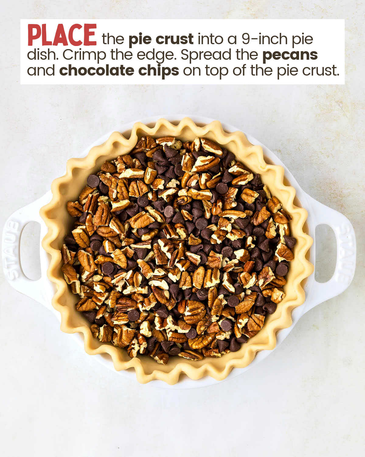 Pecans and chocolate chips in an unbaked pie crust in a pie dish. 
