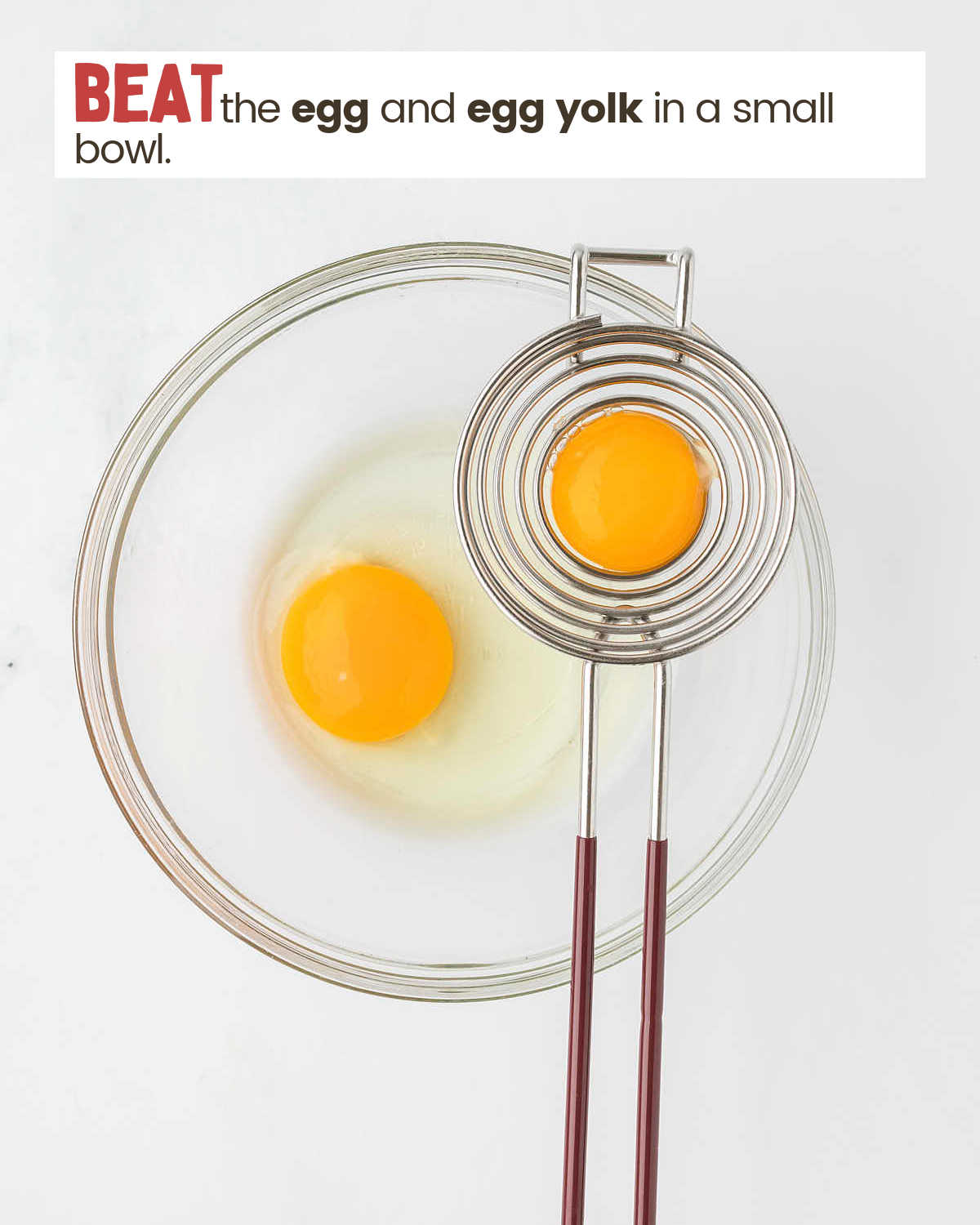 An egg is in an egg separator hovering over a bowl with a cracked egg.