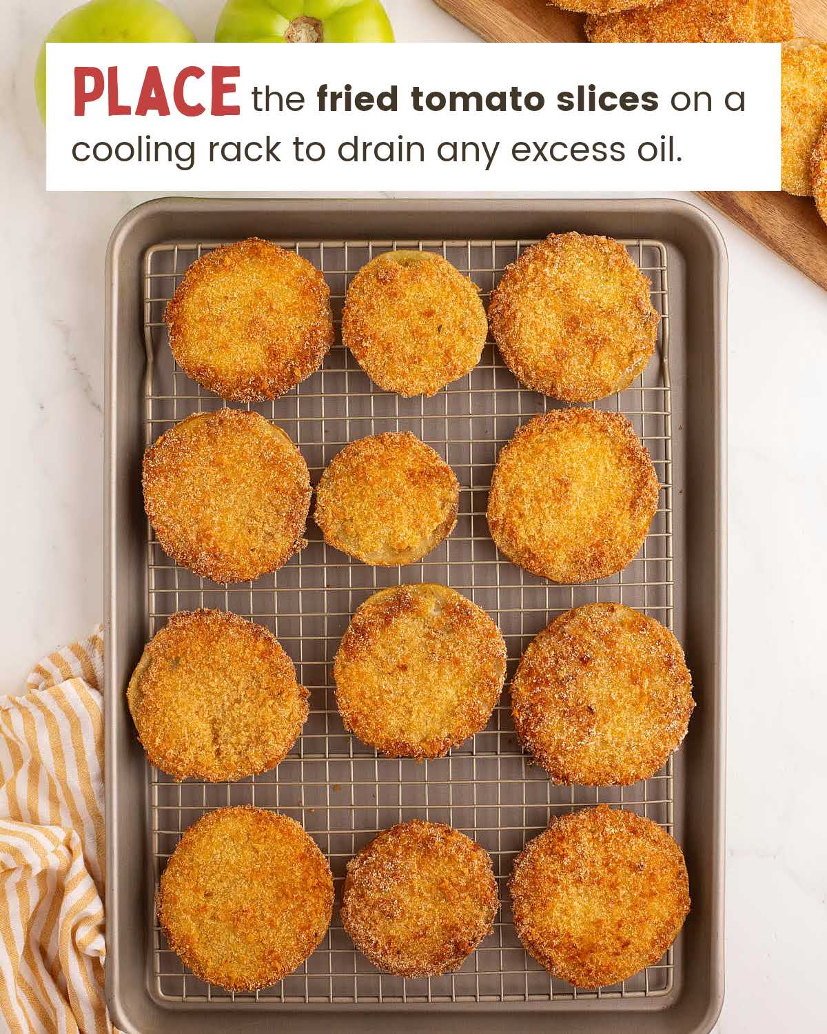 Breaded fried green tomatoes on a cooling rack.