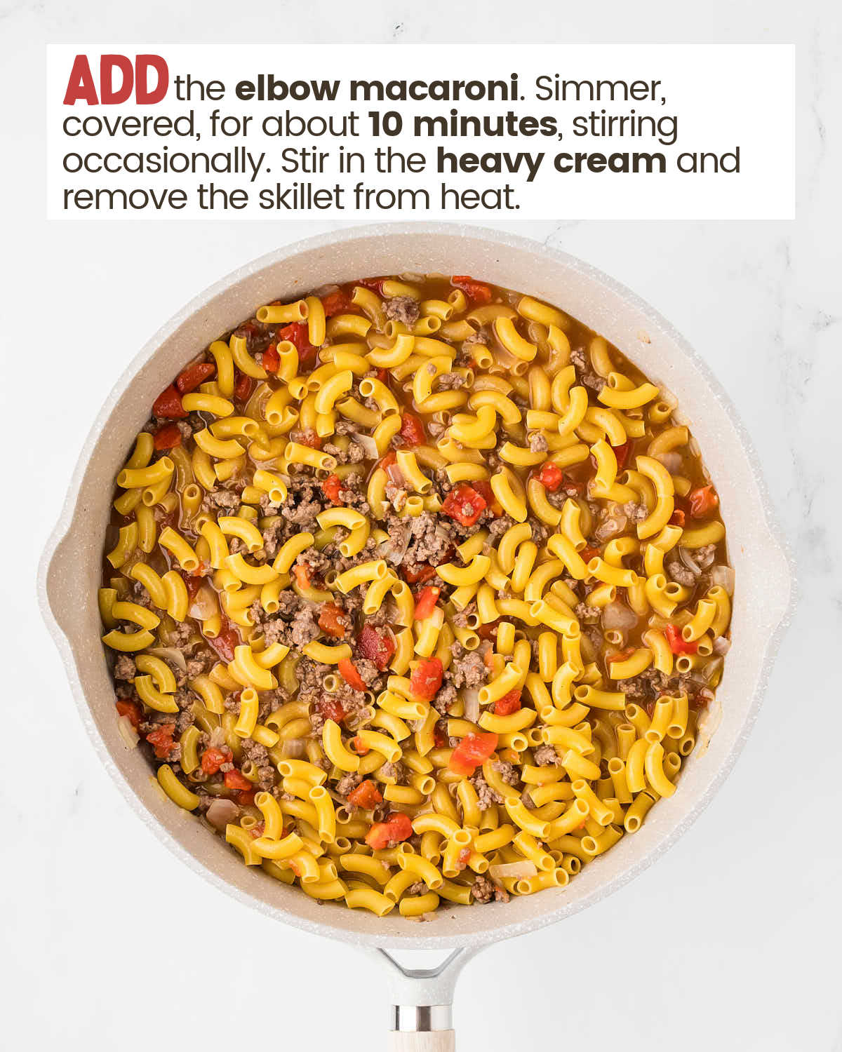 Macaroni and beef mixture in a skillet.