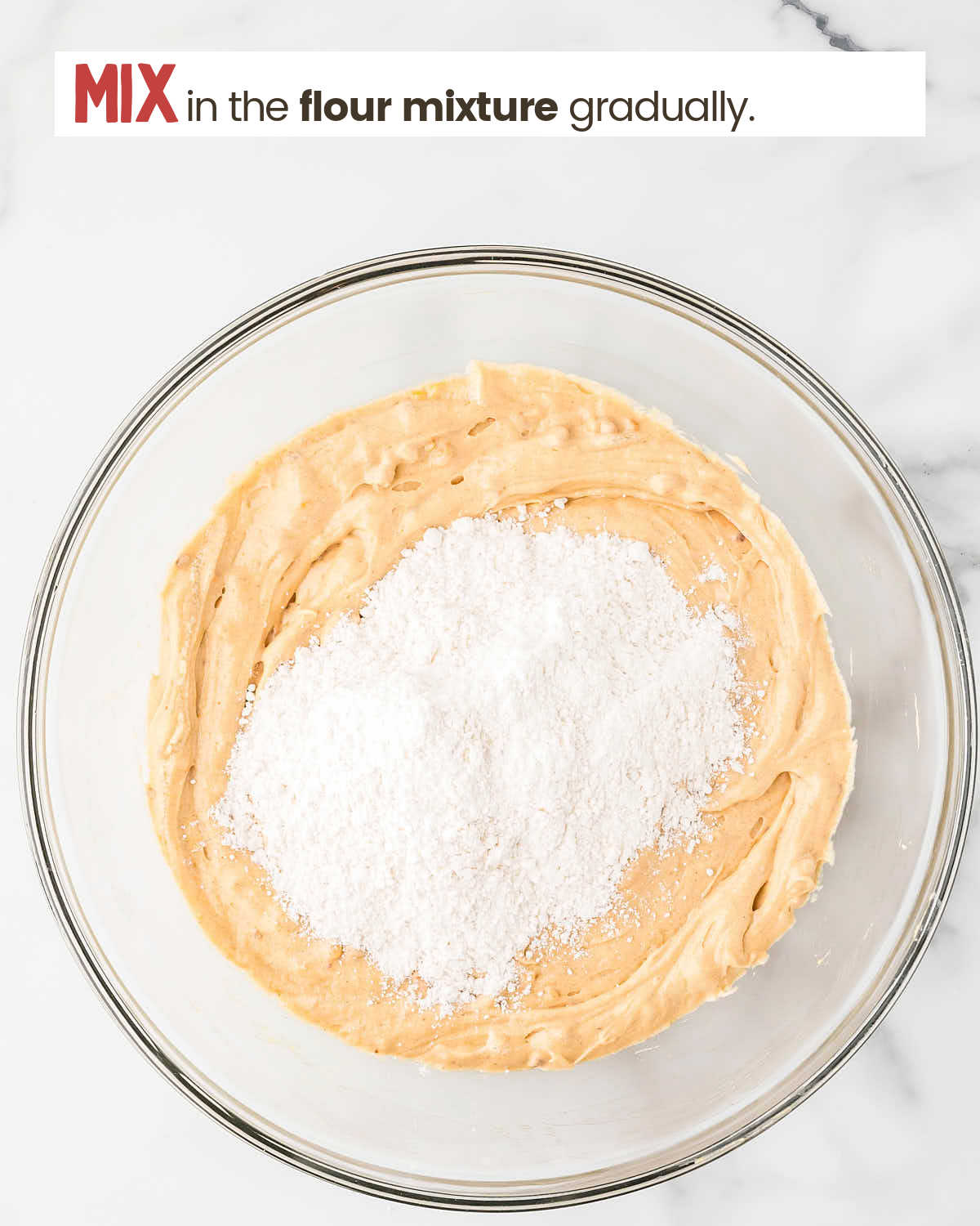 Cookie batter in a bowl with flour to be mixed in.