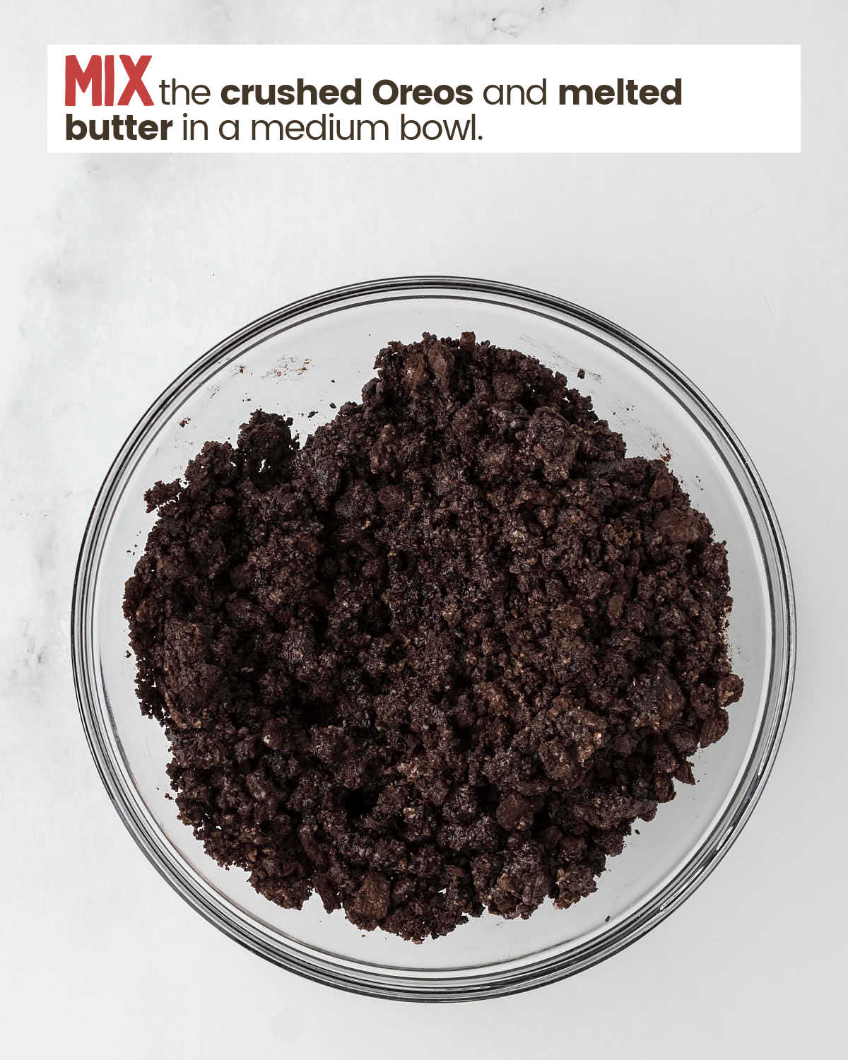 Crushed Oreos and melted butter in a bowl.
