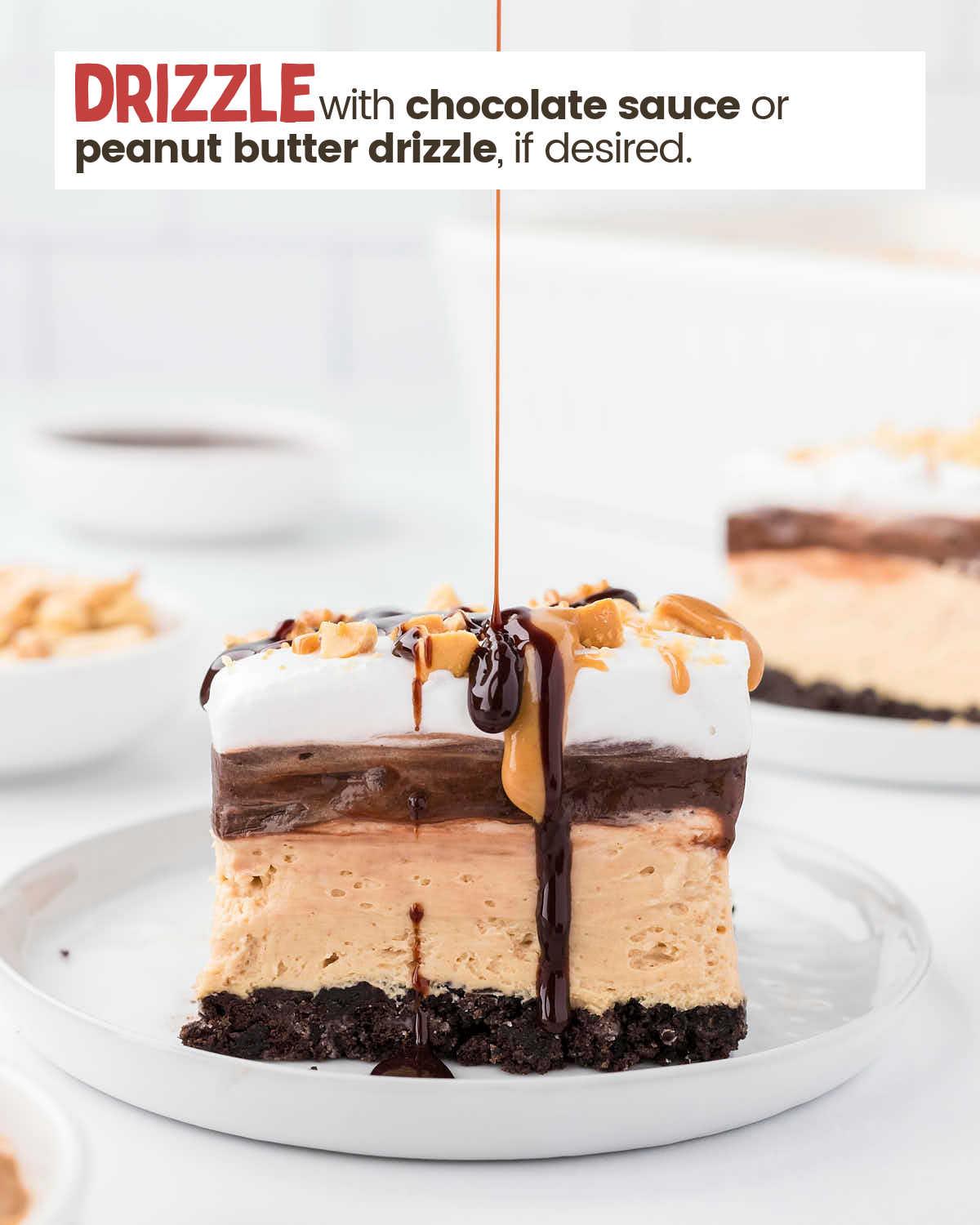 A square of peanut butter lasagna on a plate being drizzled with a peanut butter drizzle.