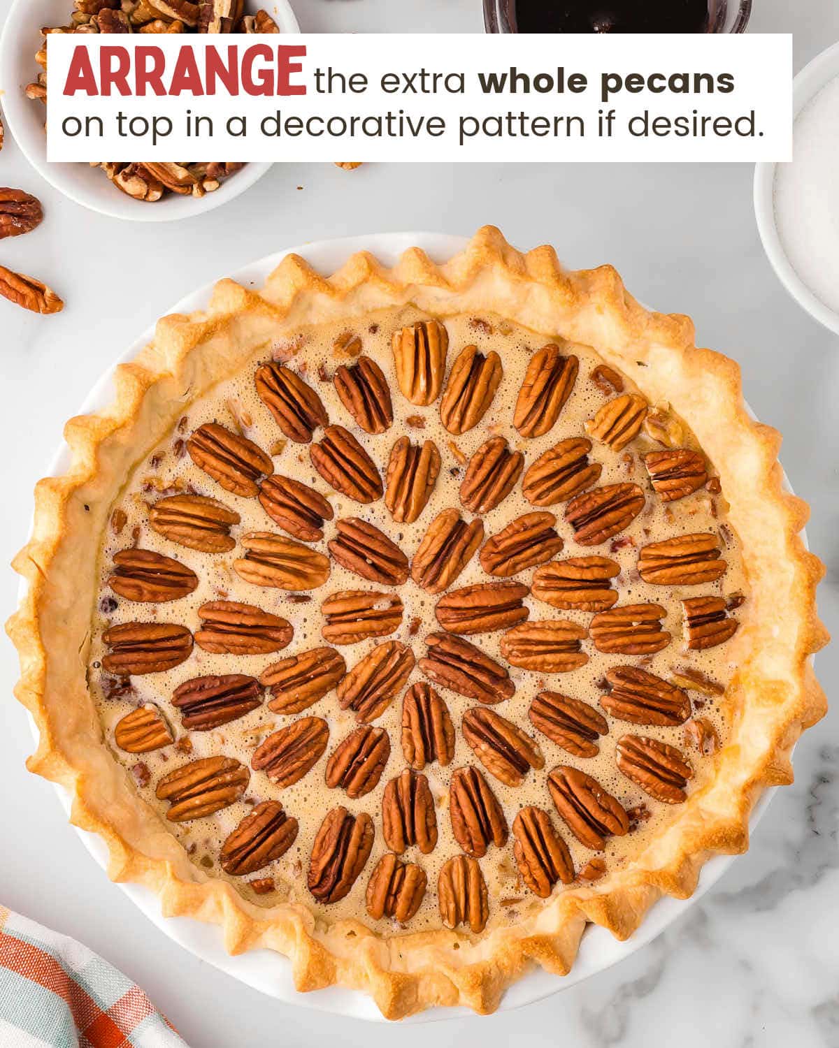 Pecan pie filling in a pie crust with whole pecans arranged on top.