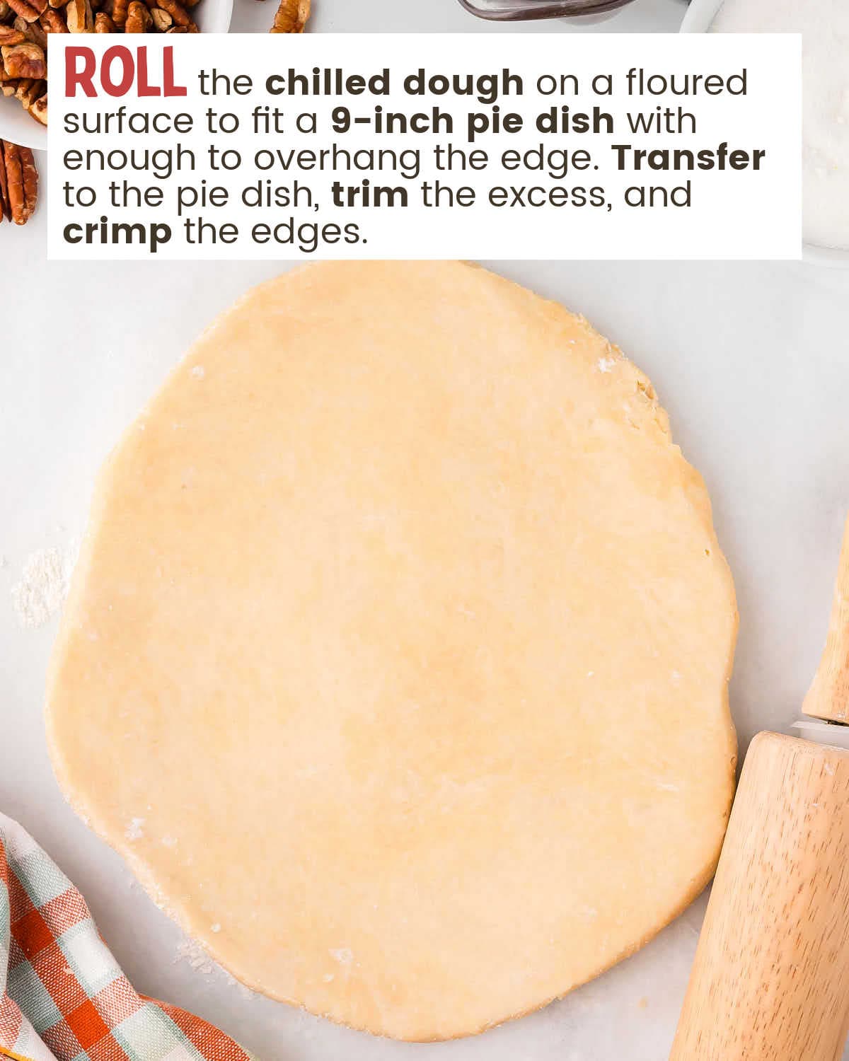 Pie crust dough rolled flat with a rolling pin nearby.