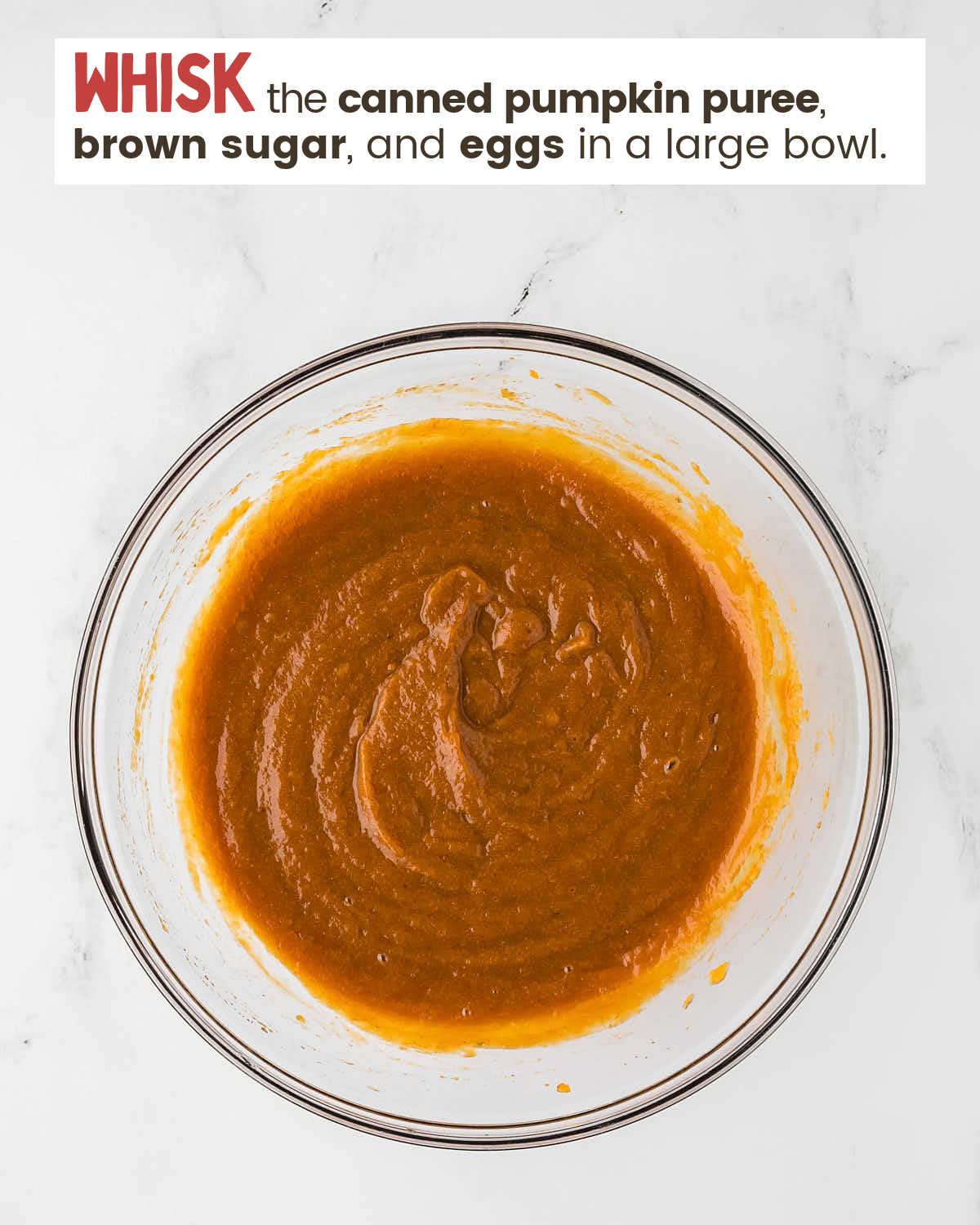 Pumpkin pie ingredients are whisked in a bowl.