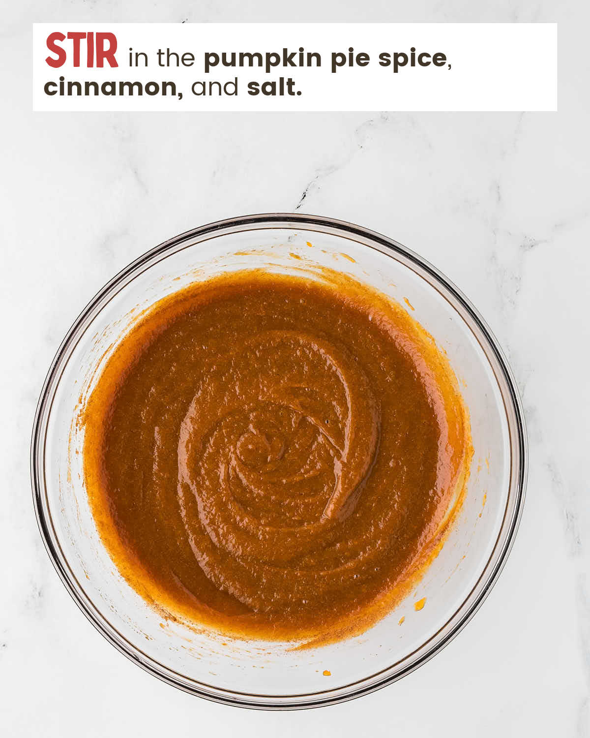 Pumpkin pie ingredients are whisked in a bowl.