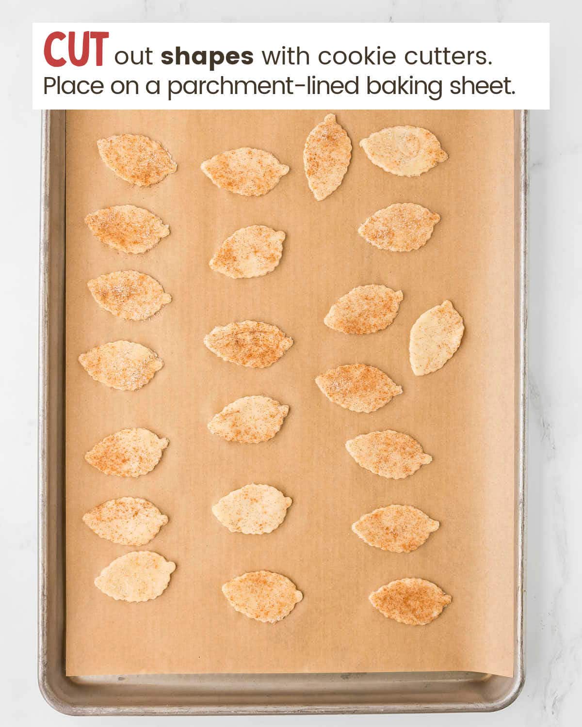 pie crust into leaf-shaped pieces on a baking tray.