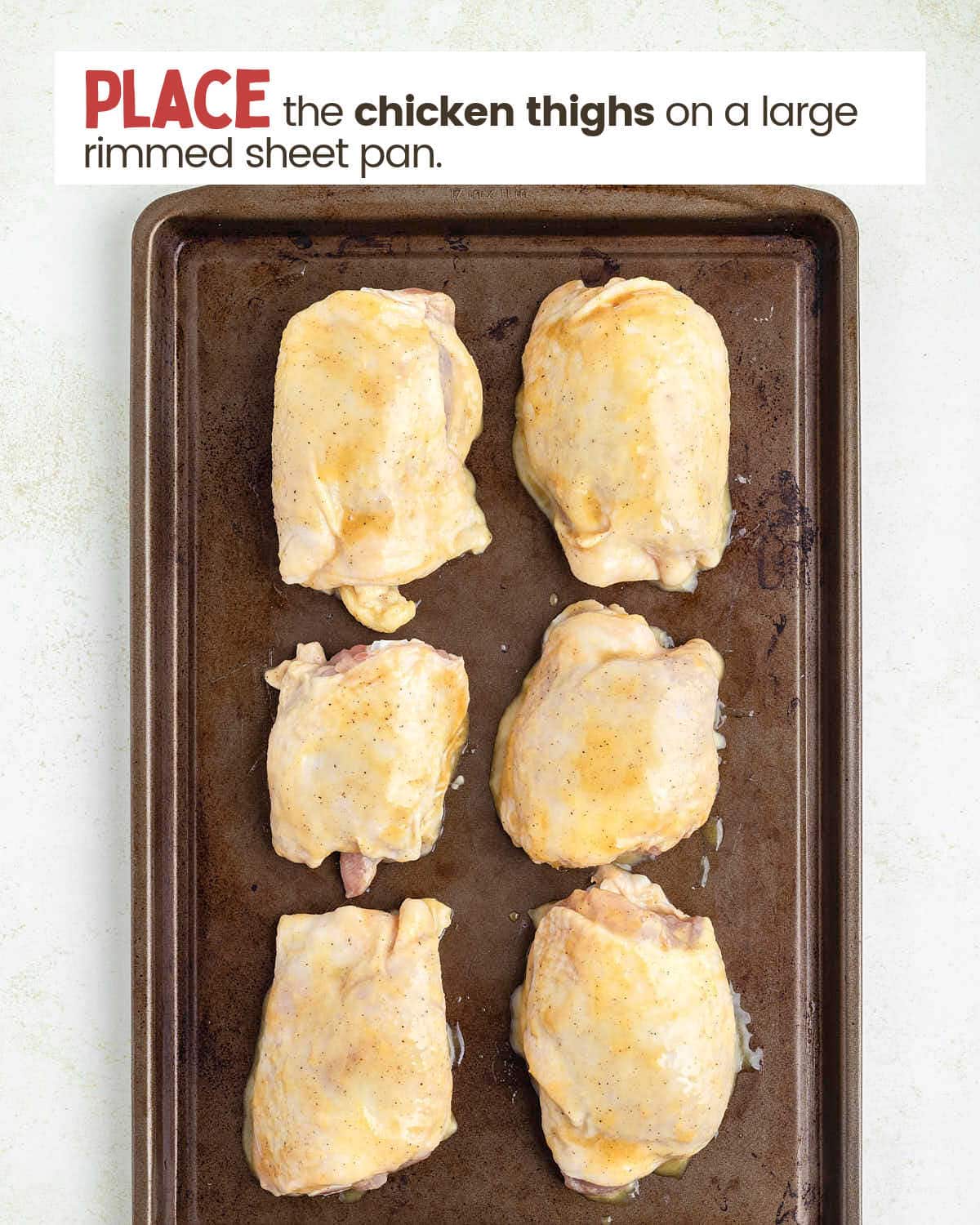 Chicken thighs on a sheet pan.