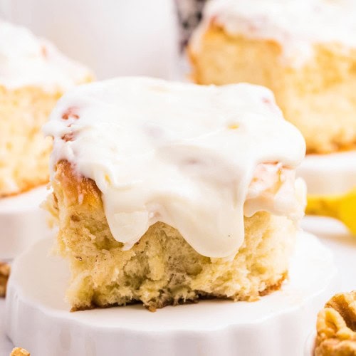 Closeup of a Banana Cinnamon Roll on a white plate.