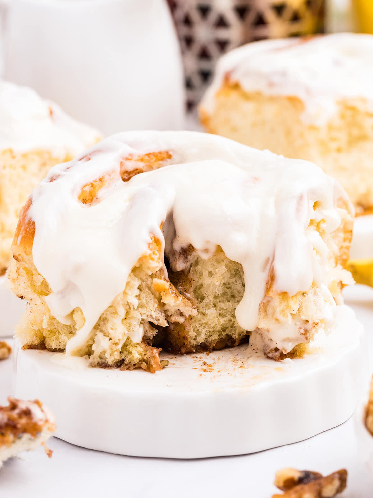 A slice of Banana Cinnamon Roll on a white plate.