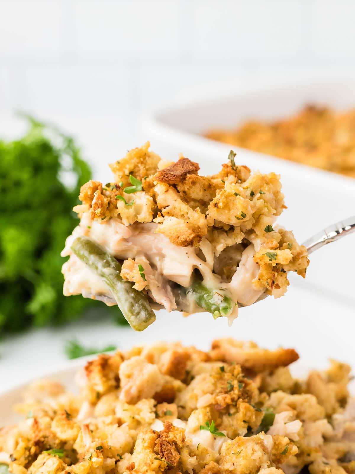 Closeup of a spoonful of Chicken and Stuffing Casserole recipe.