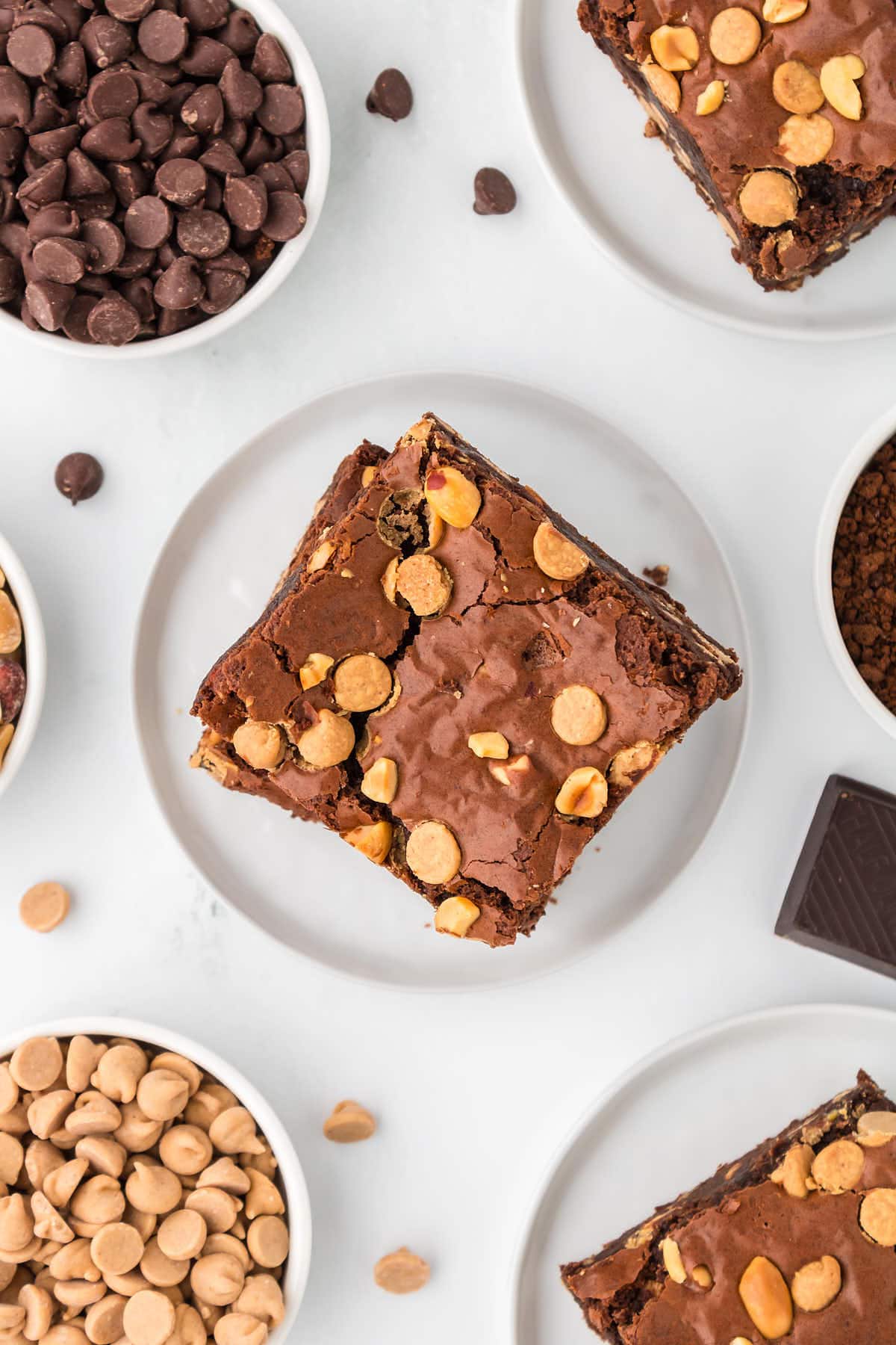 Topdown view of a stack of brownies on a white plate.
