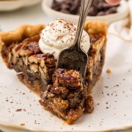 A fork holding a slice of Chocolate Pecan Pie.