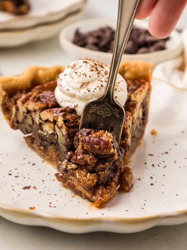 A fork holding a slice of Chocolate Pecan Pie.