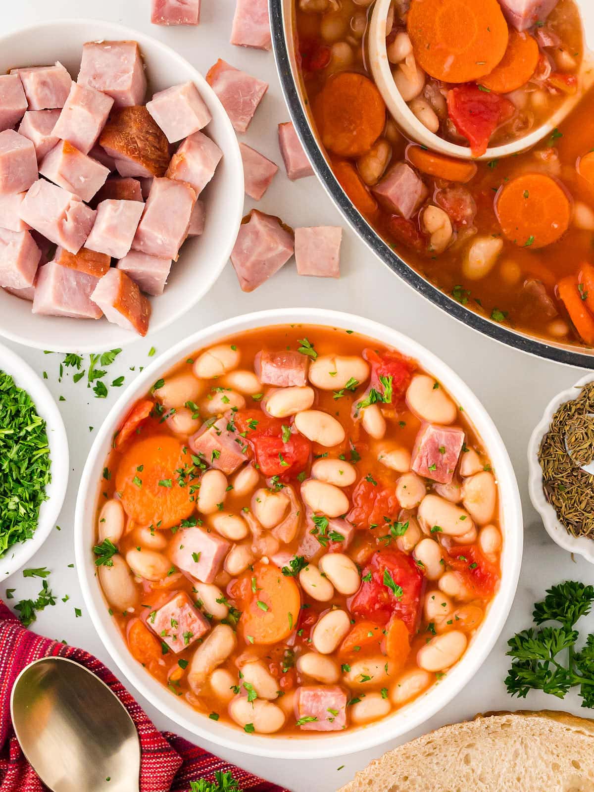 Topdown view of a bowl of Ham and Bean Soup served in a white bowl.