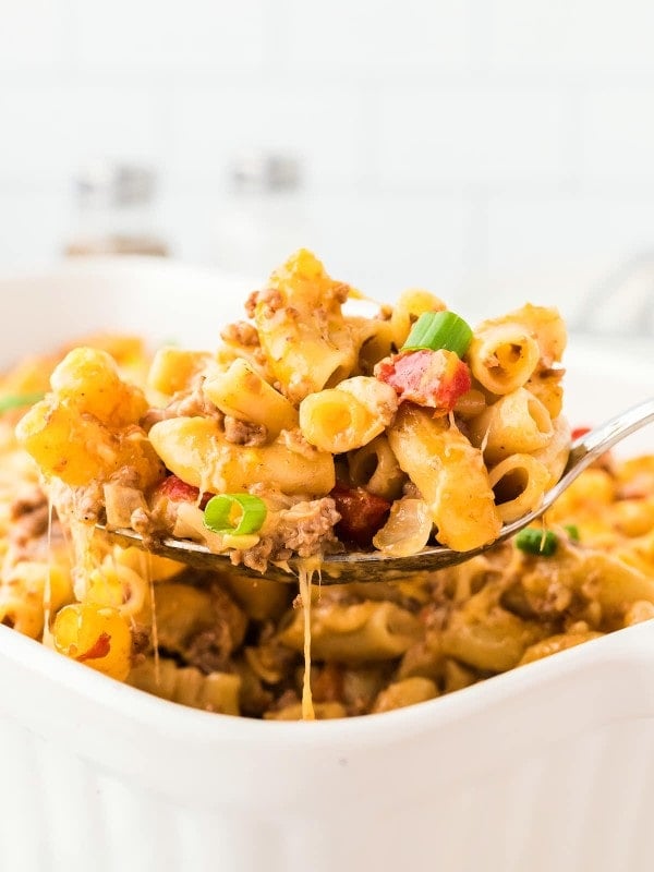 A serving spoon full of a Hamburger Casserole.