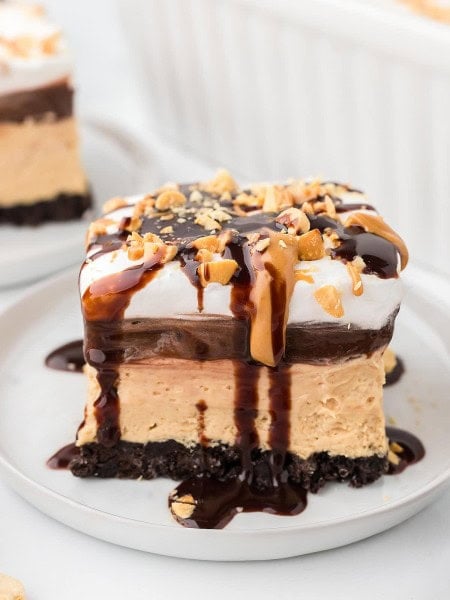 A slice of No-Bake Peanut Butter Lasagna served on a white plate.