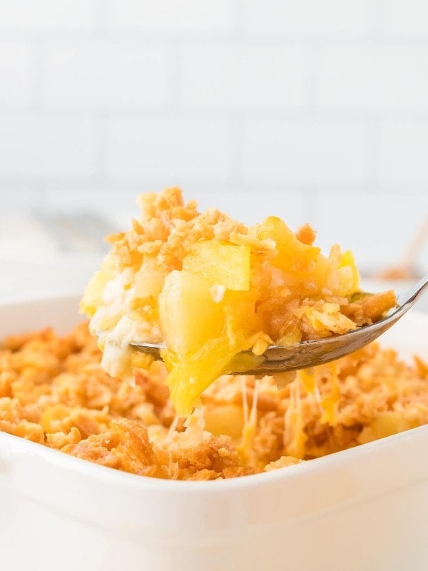 A serving spoonful of Pineapple Casserole.