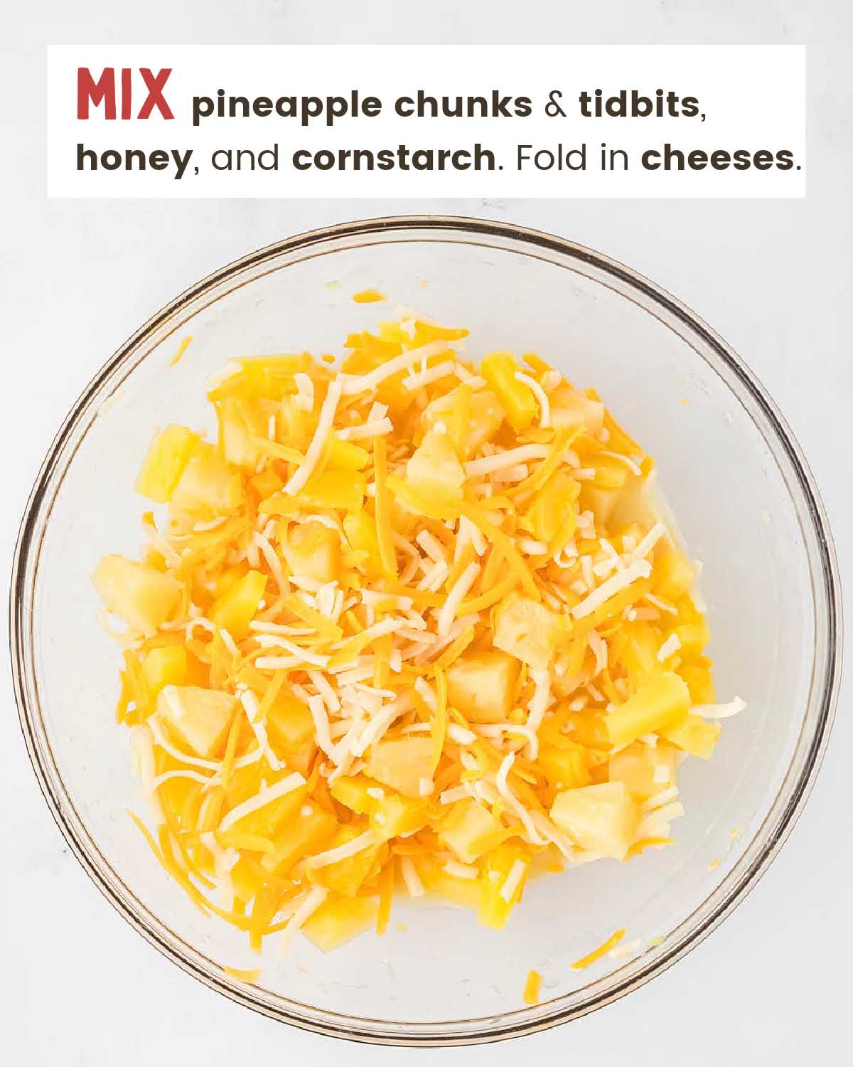 Pineapple chunks and cheese in bowl.