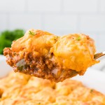 A serving spoonful of Sloppy Joe Casserole being moved from a casserole dish.