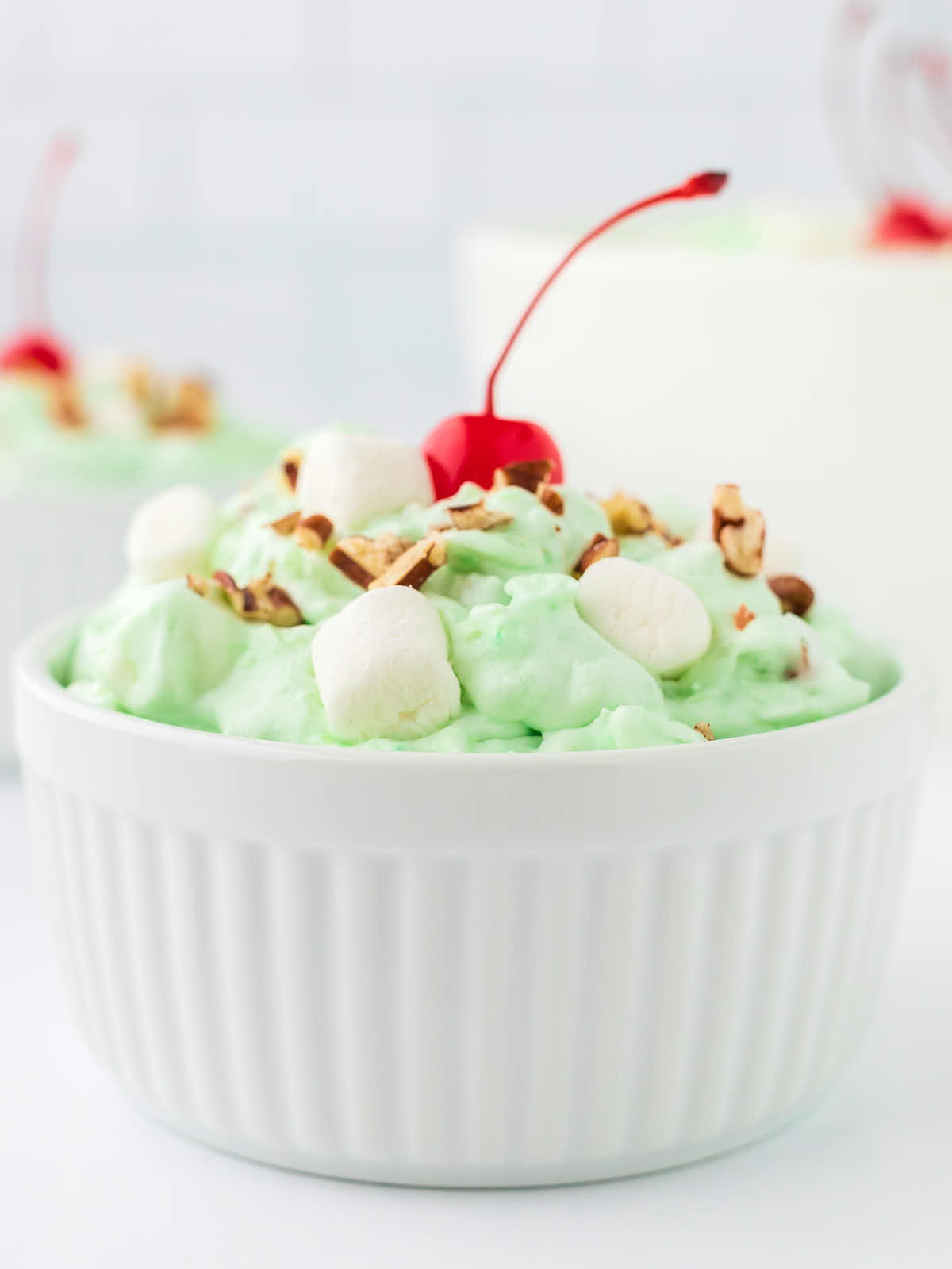 Closeup of a Watergate Salad in a white bowl.