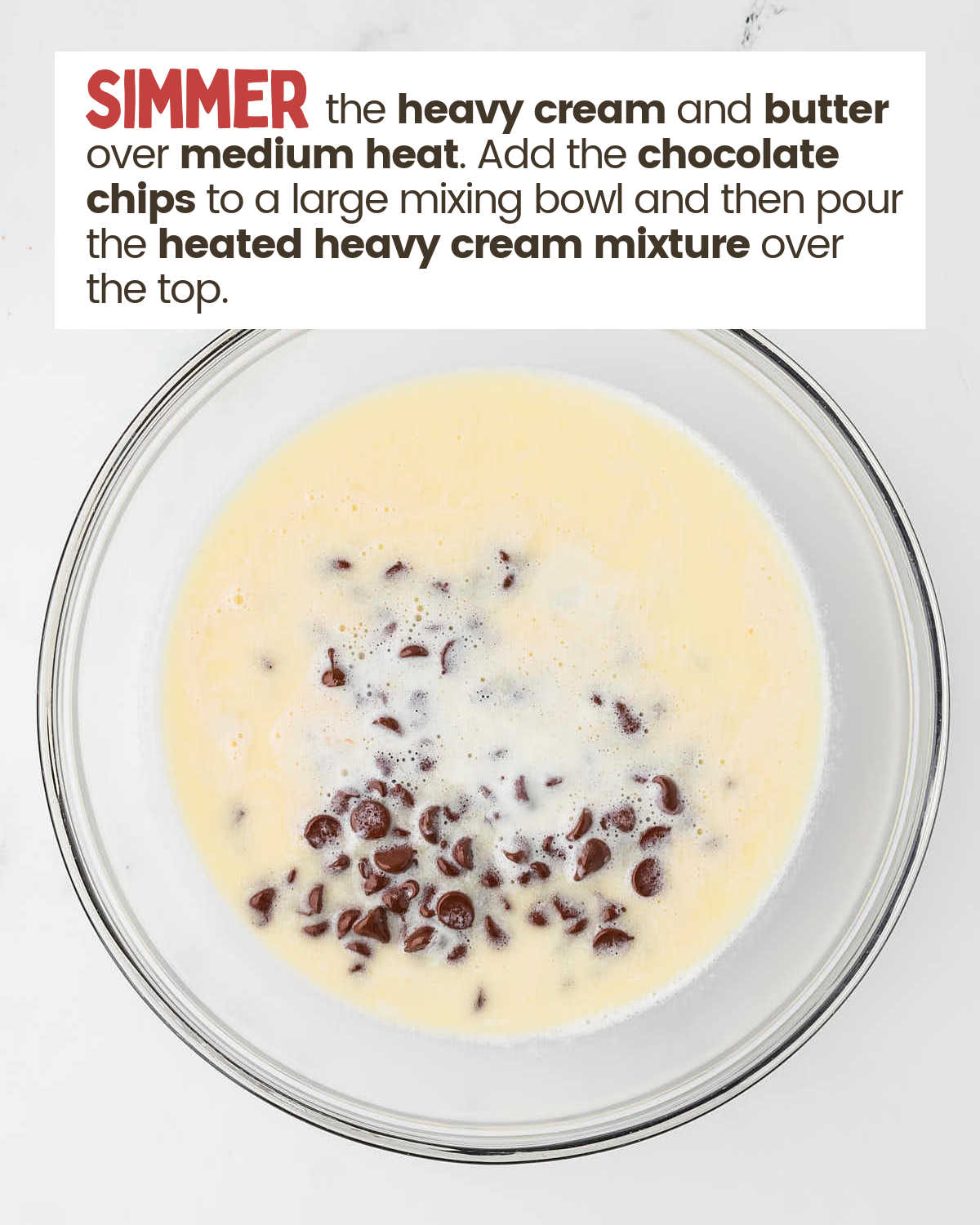 Heavy cream over chocolate chips in a bowl.