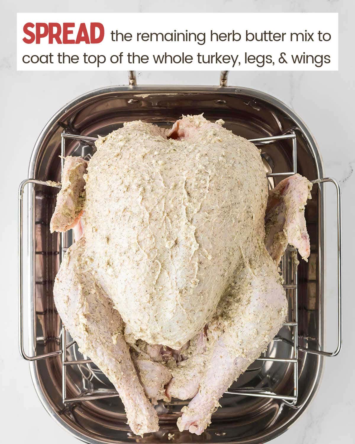 Spreading remaining herb butter mixture on the outside of the turkey.