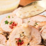 Drizzling white wine shallot sauce over sliced Chicken Rouladen.