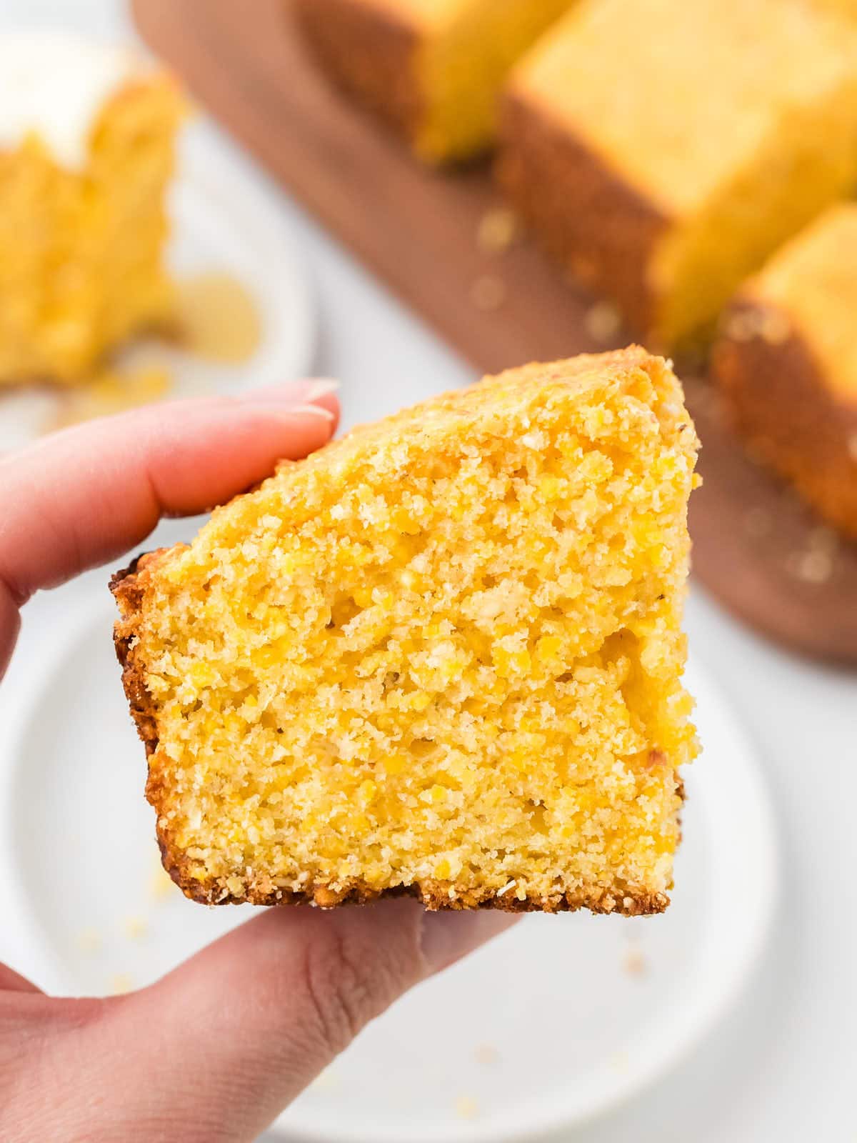Holding a slice of Cornbread.