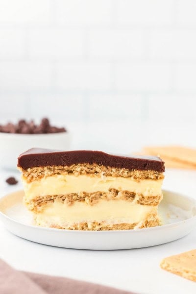 A slice of No-Bake Eclair Cake on a white plate.