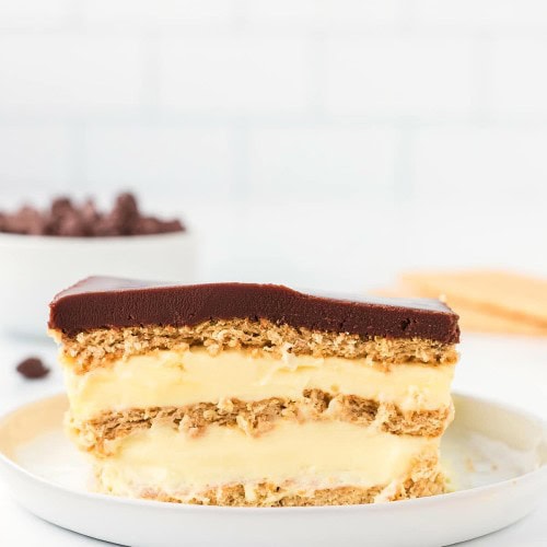 A slice of No-Bake Eclair Cake on a white plate.