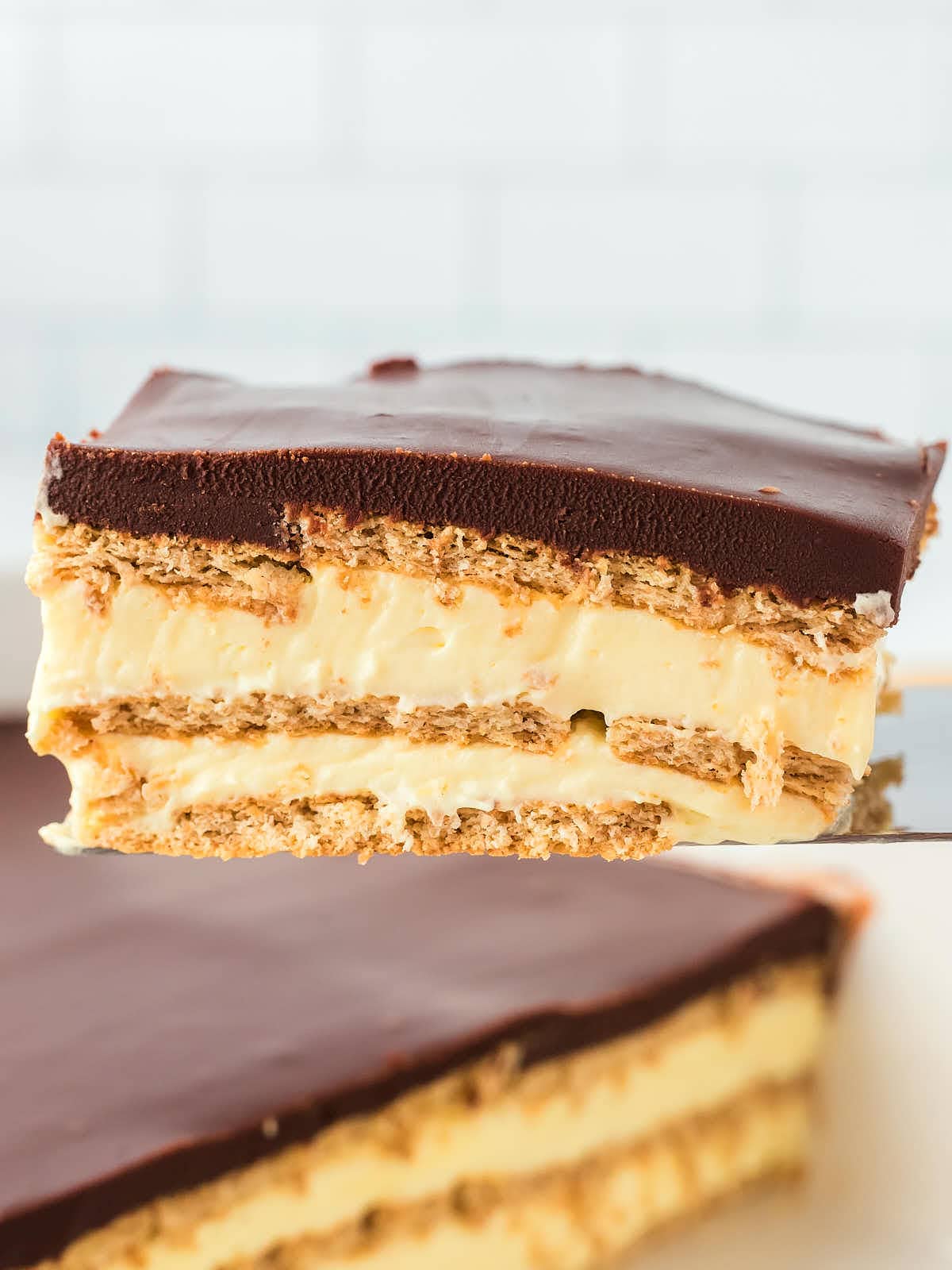 A slice of Eclair Cake on a serving spatula.
