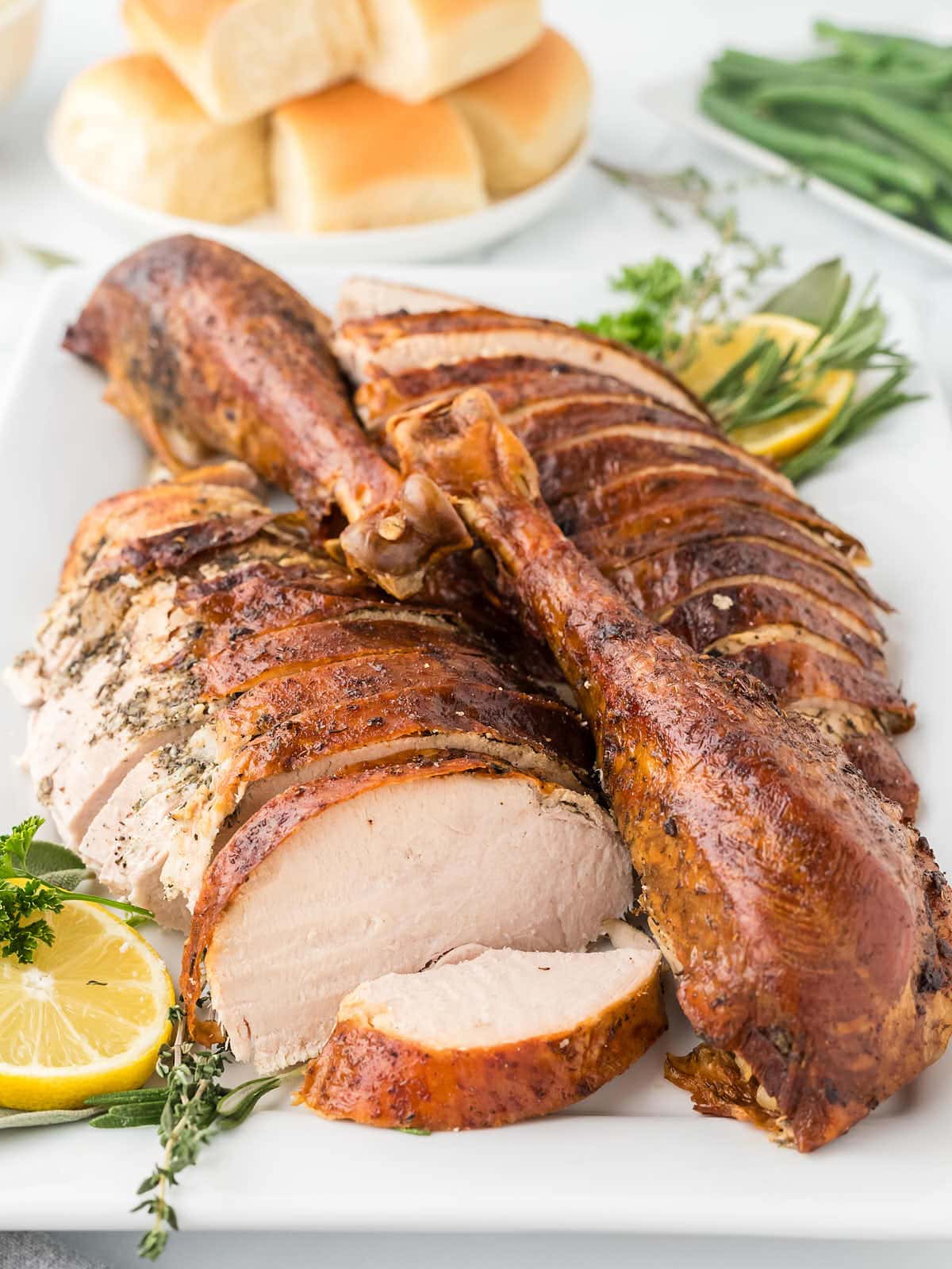 Carved Thanskgiving Turkey on a white plate.