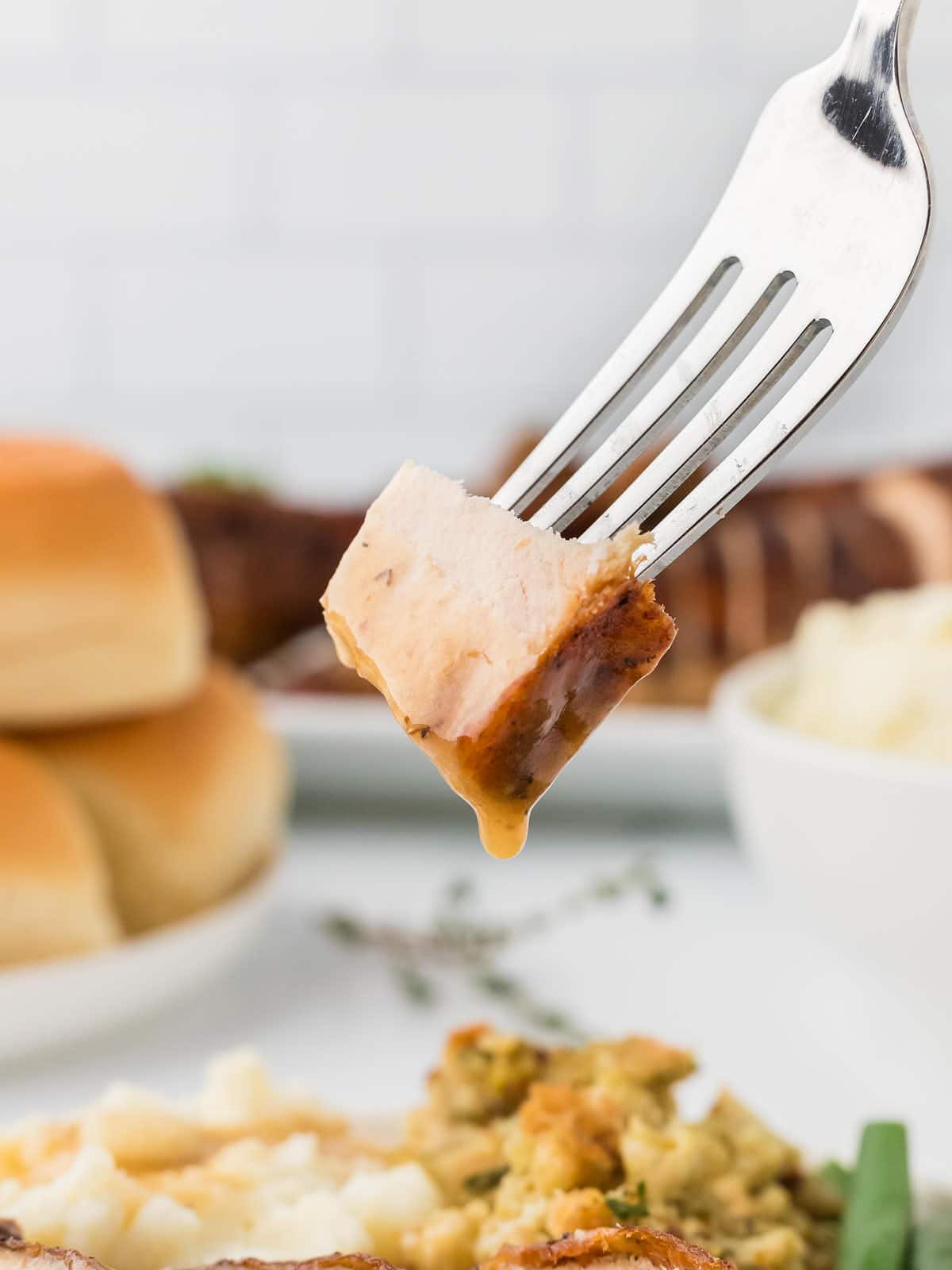 A forkful a Turkey with gravy. 