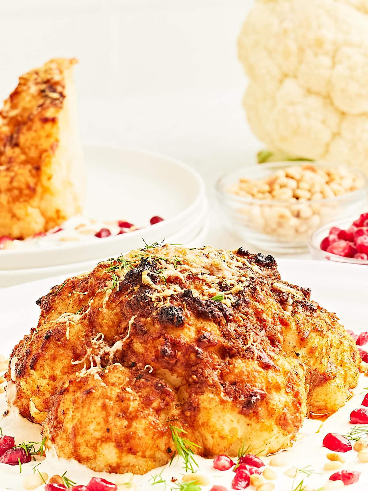 A Whole Roasted Cauliflower served on a lemon cream sauce.