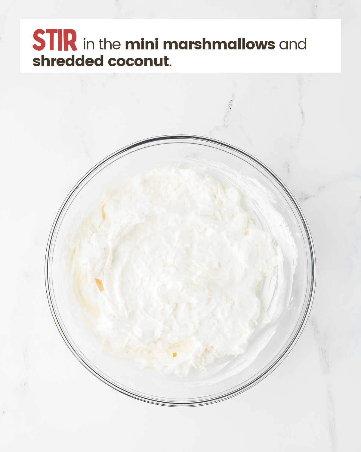 Whipped topping, vanilla yogurt, sour cream, mini marshmallows and shredded coconut mixed in a bowl.