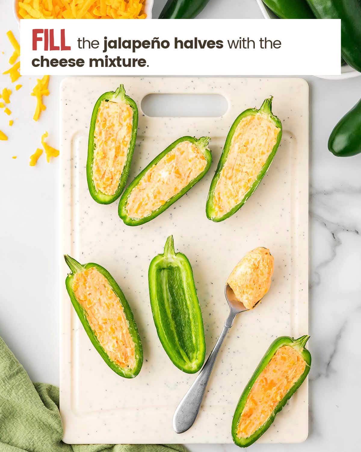 Jalapeños stuffed with a cheese mixture on a cutting board.