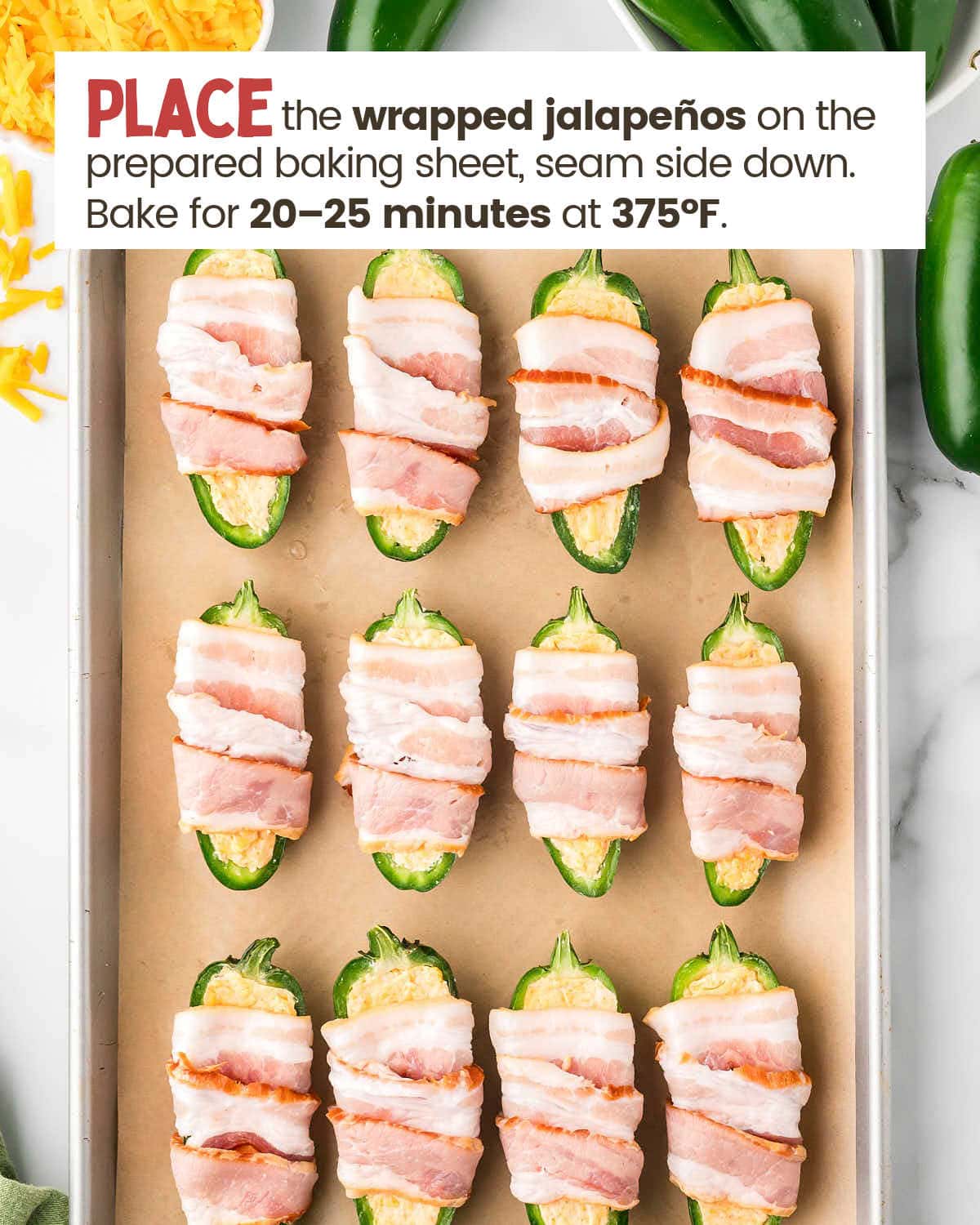 Uncooked Jalapeños poppers on a baking sheet lined with parchment.