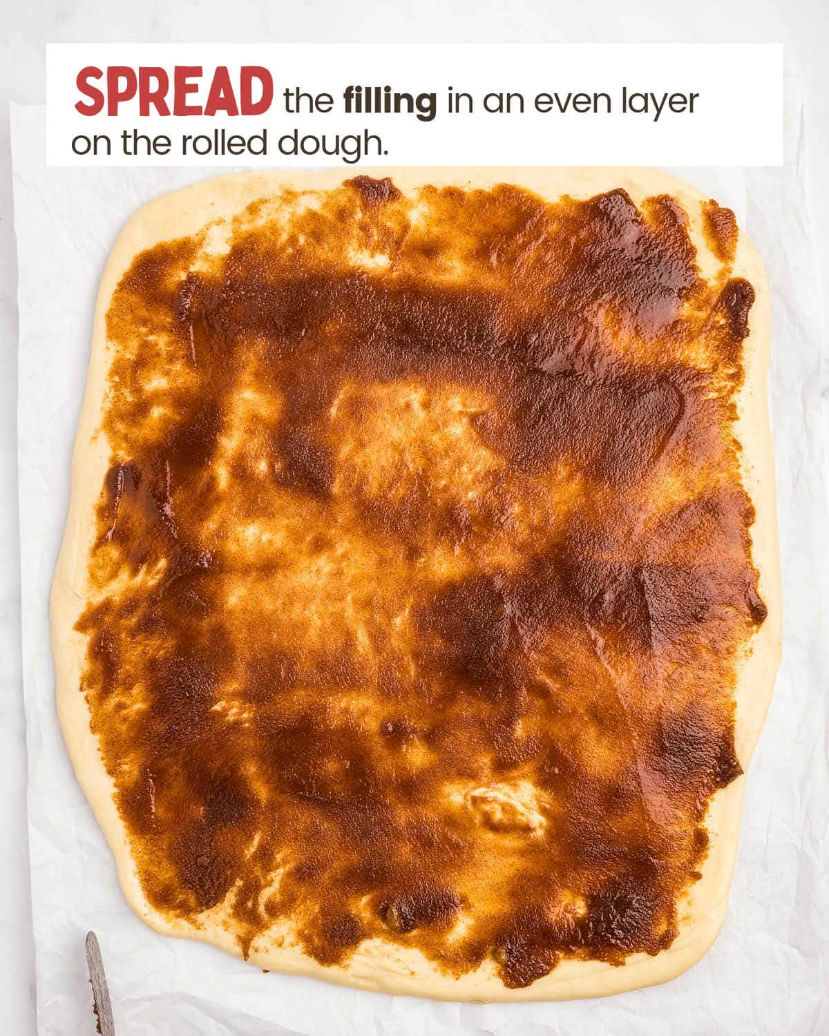 A flat piece of dough covered with a layer of cinnamon filling.