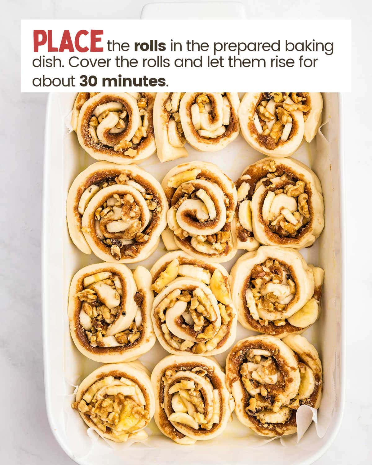 Unbaked banana cinnamon rolls in a baking dish.
