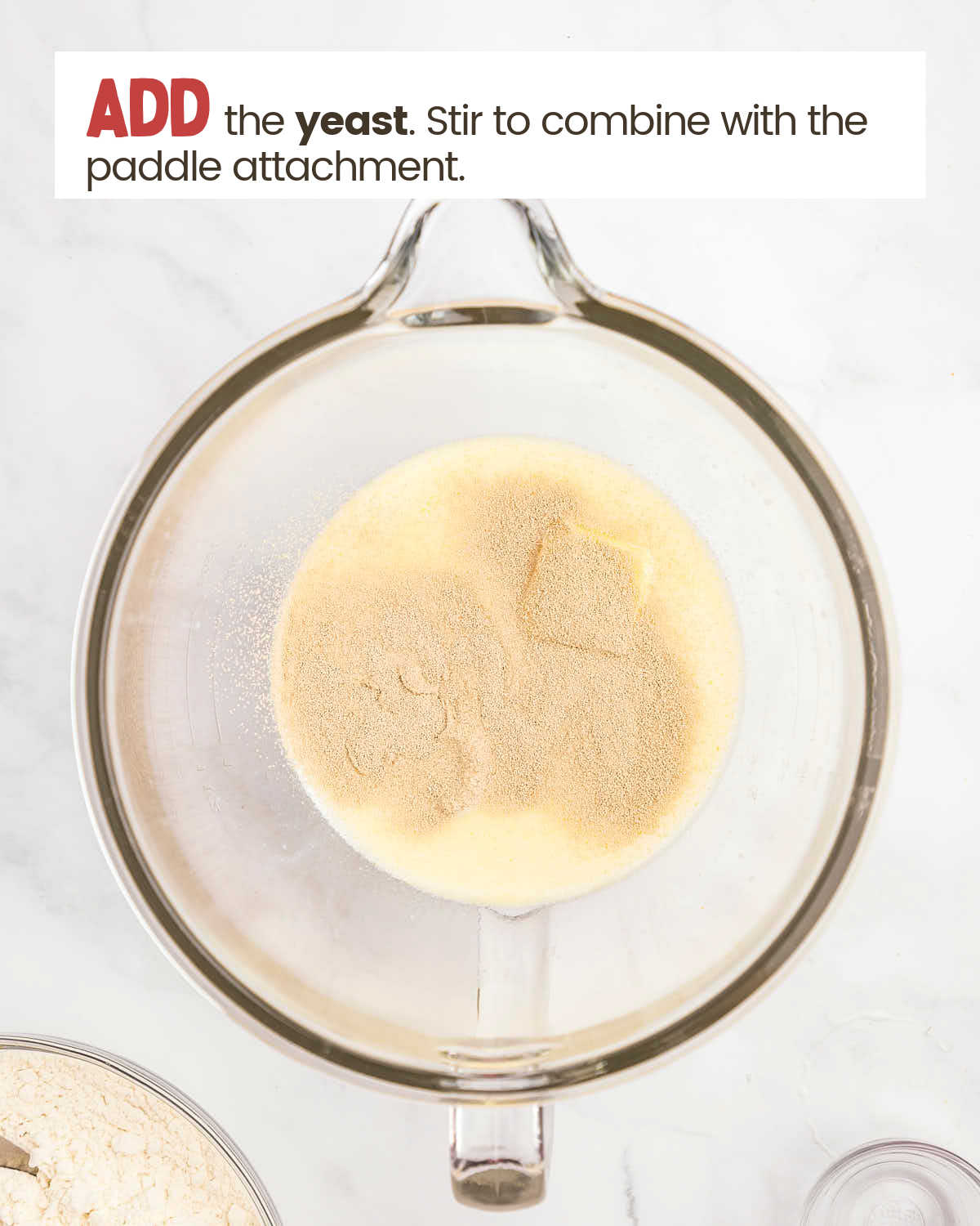 Melted butter mixture with yeast in a glass bowl.