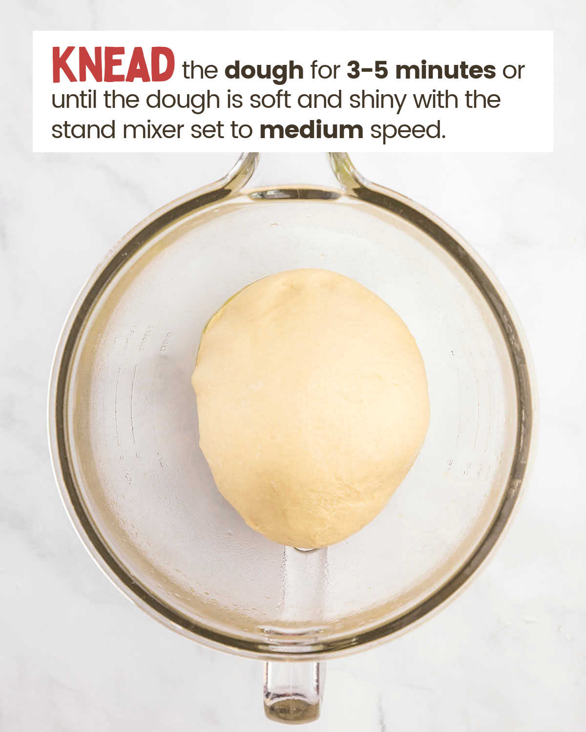 A dough ball in a glass bowl.