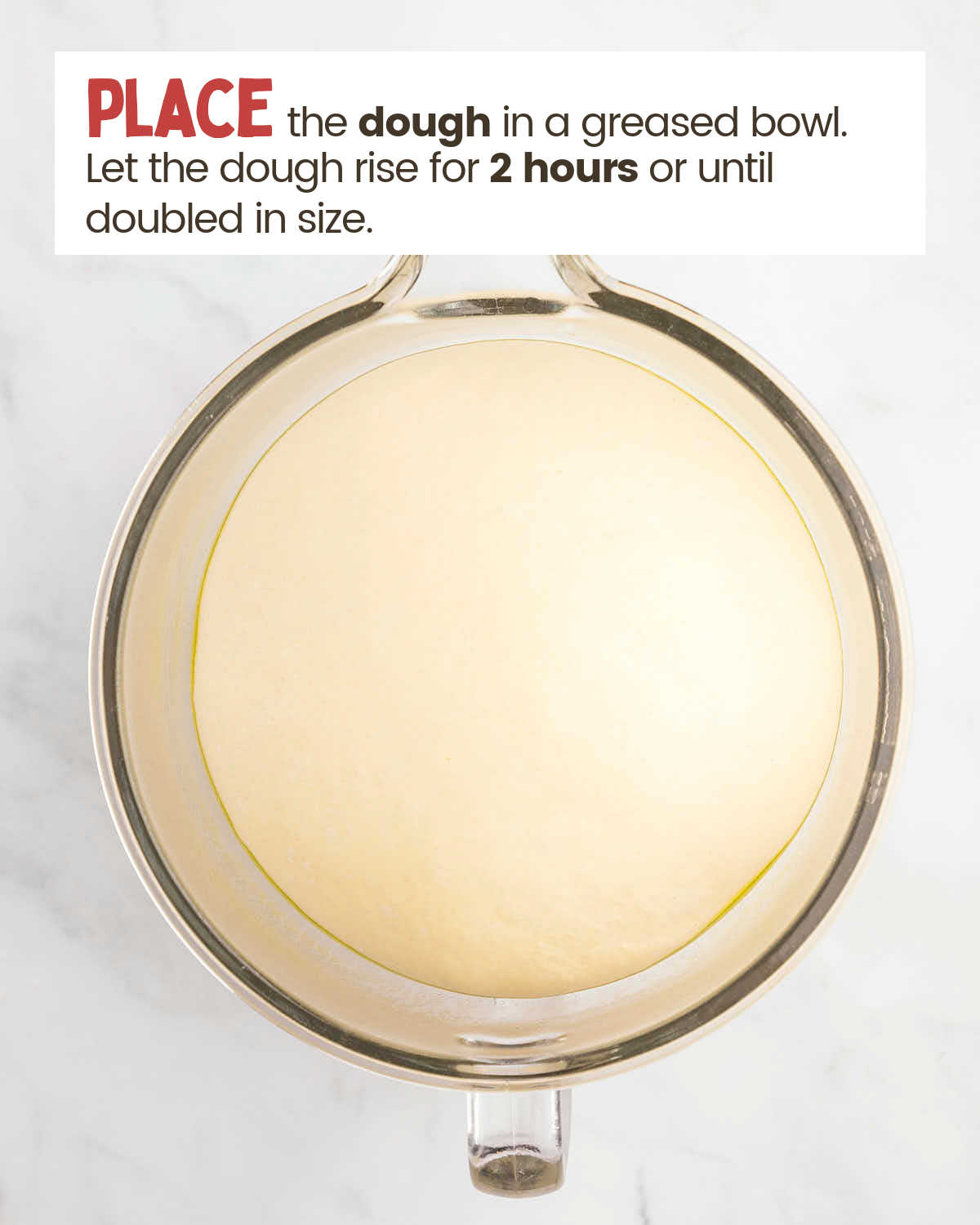 A dough ball in a glass bowl.