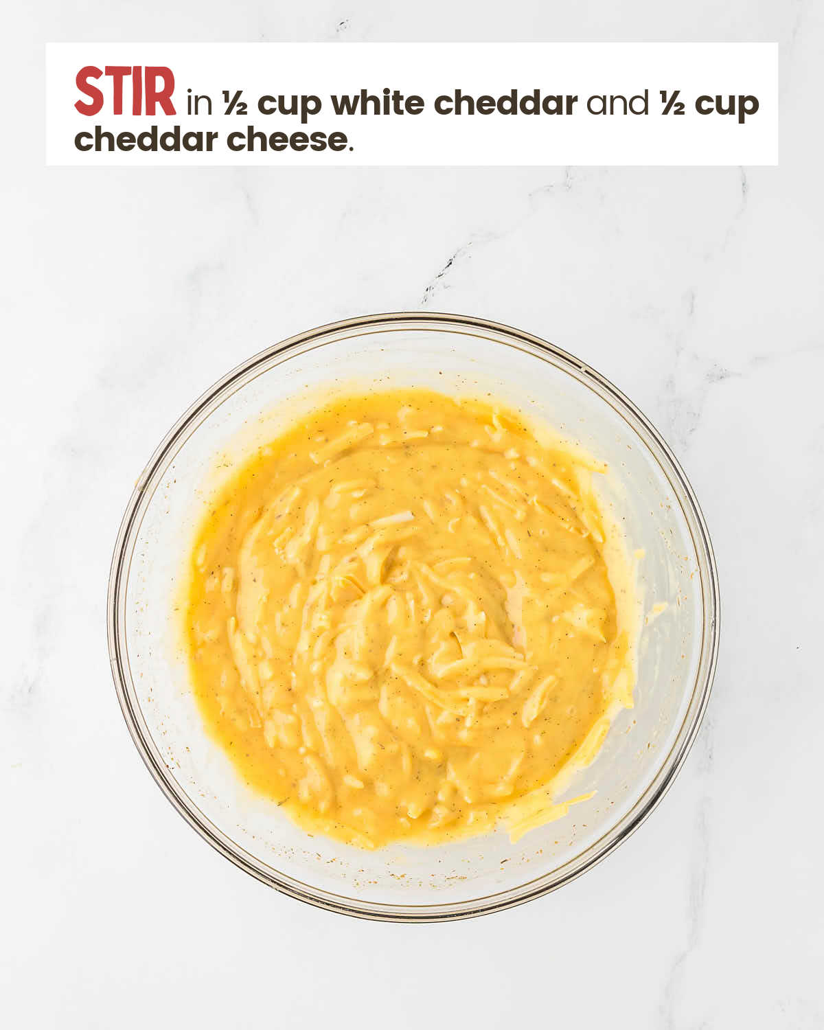 Soup mixture with cheese in a large bowl.